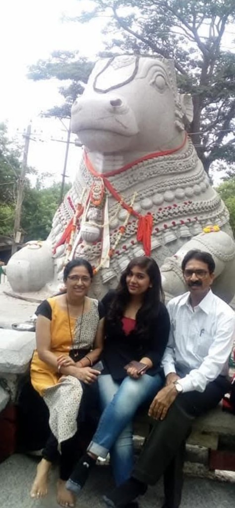 Travellers with Nandi statue at a temple stop