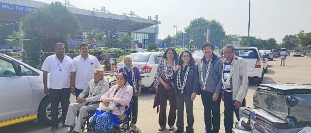 Happy travellers with their car on an India road trip